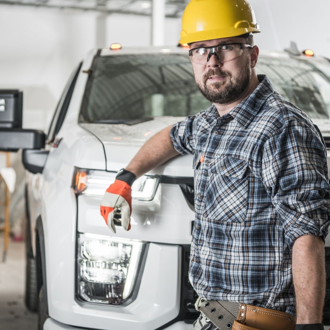 a man in safety gear in front of a truck